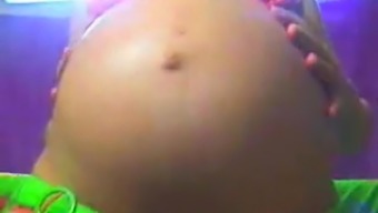 A Pregnant Brunette Is Clad In Skimpy Neon Bikini And Flashing Her Big Momma Tits