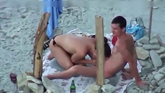 A Couple Is Spying On Camera At The Beach